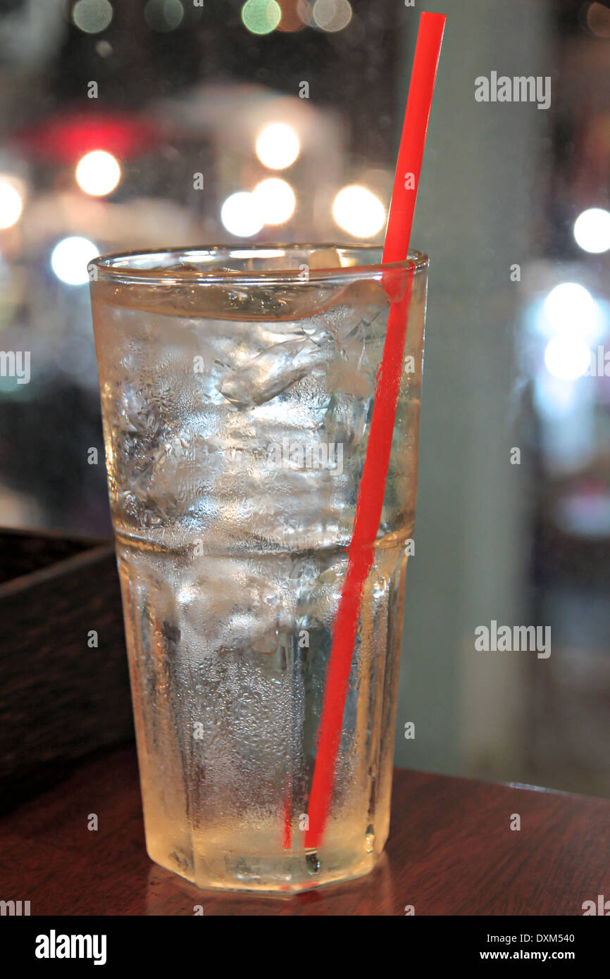 ice and water in glass on dining table at restaurant. Stock Photo