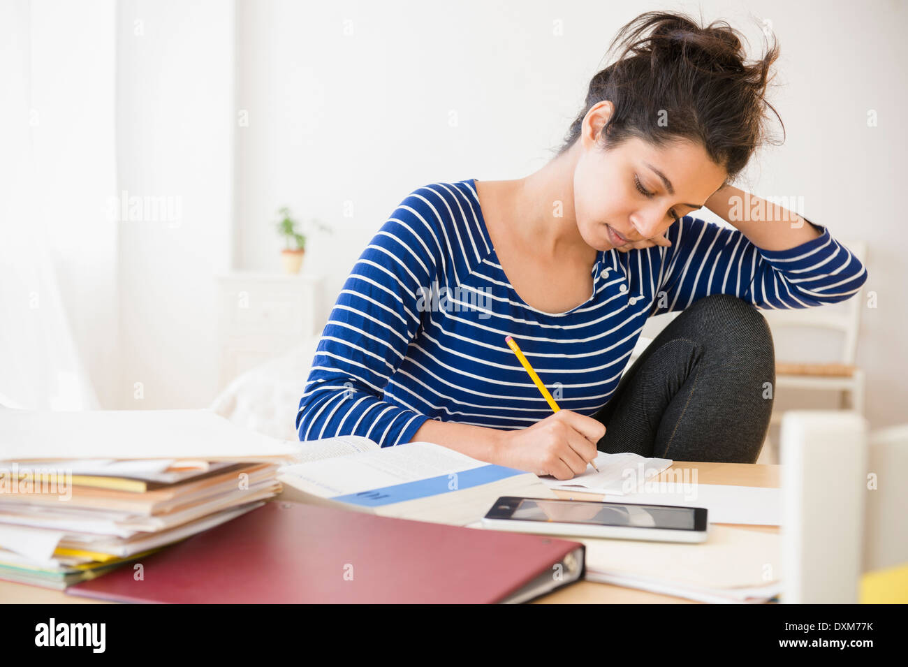 Asian student studying at table Stock Photo