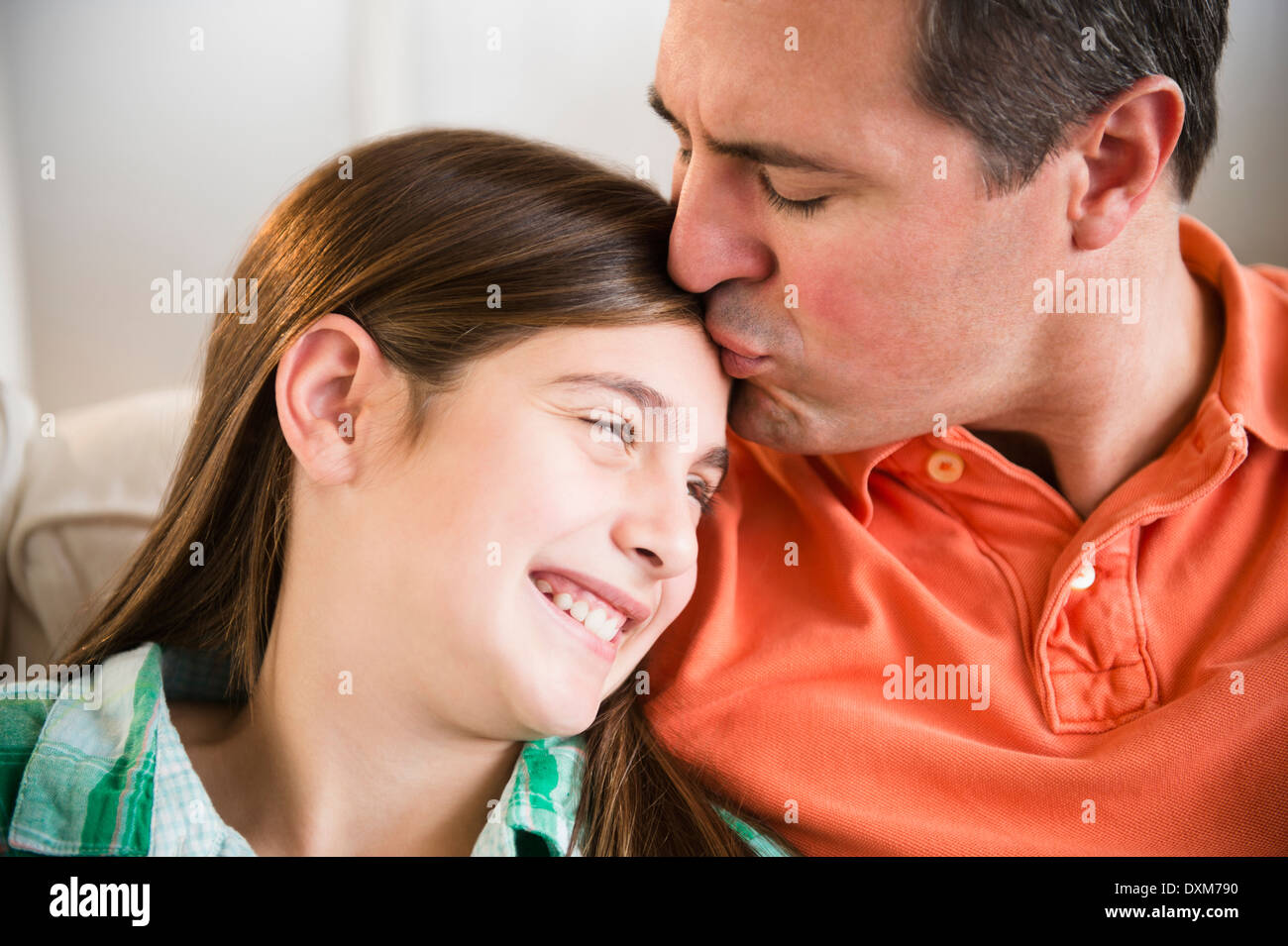 Caucasian father kissing daughter's forehead Stock Photo
