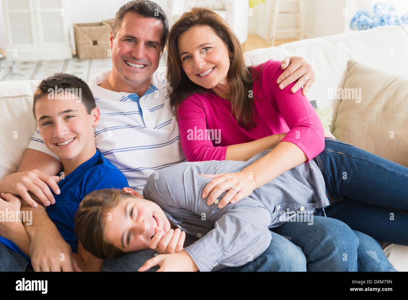 Portrait of smiling Caucasian family on sofa Stock Photo