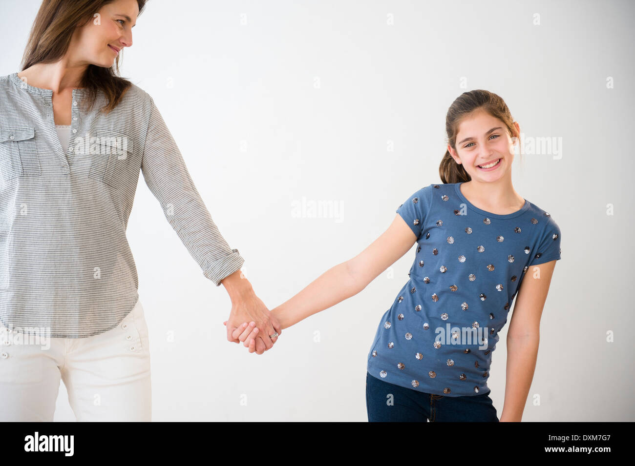 Three girls holding hands hi-res stock photography and images - Alamy