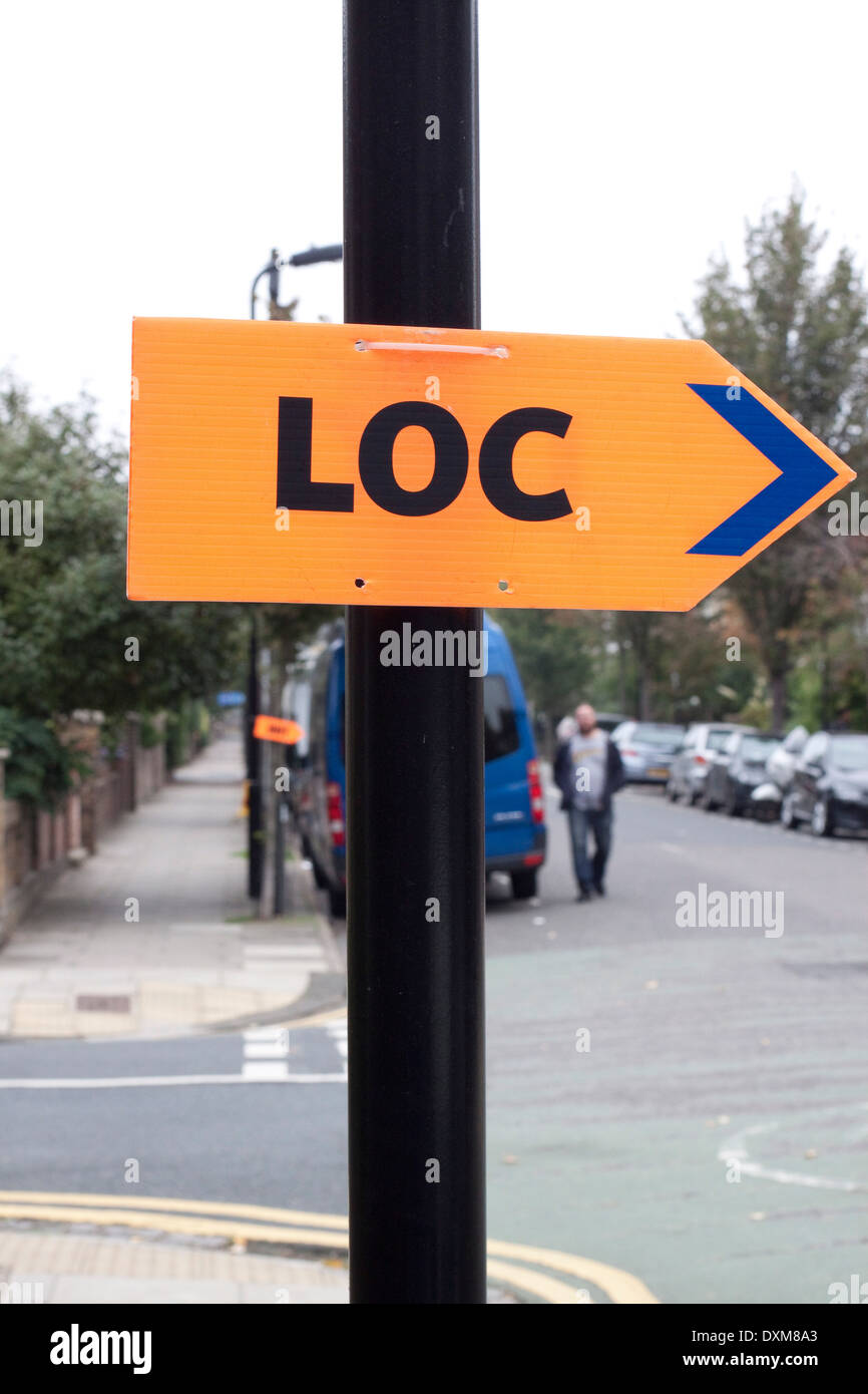 Orange LOC sign directing a film unit to an urban location Stock Photo