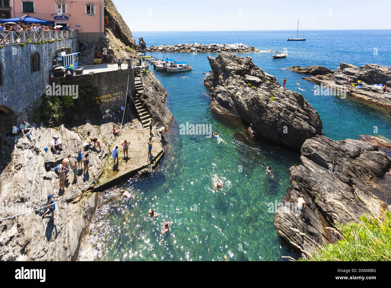 Italy, Liguria, La Spezia, Cinque Terre, Manarola, view to waterside and bathing people Stock Photo