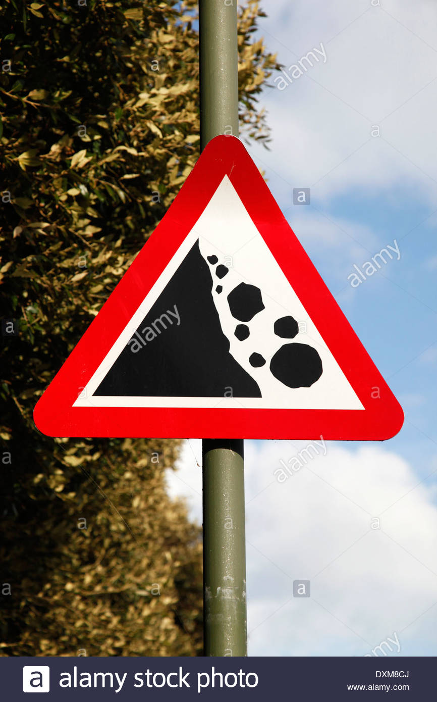 A red triangle sign warning of the danger from falling rocks from Stock ...