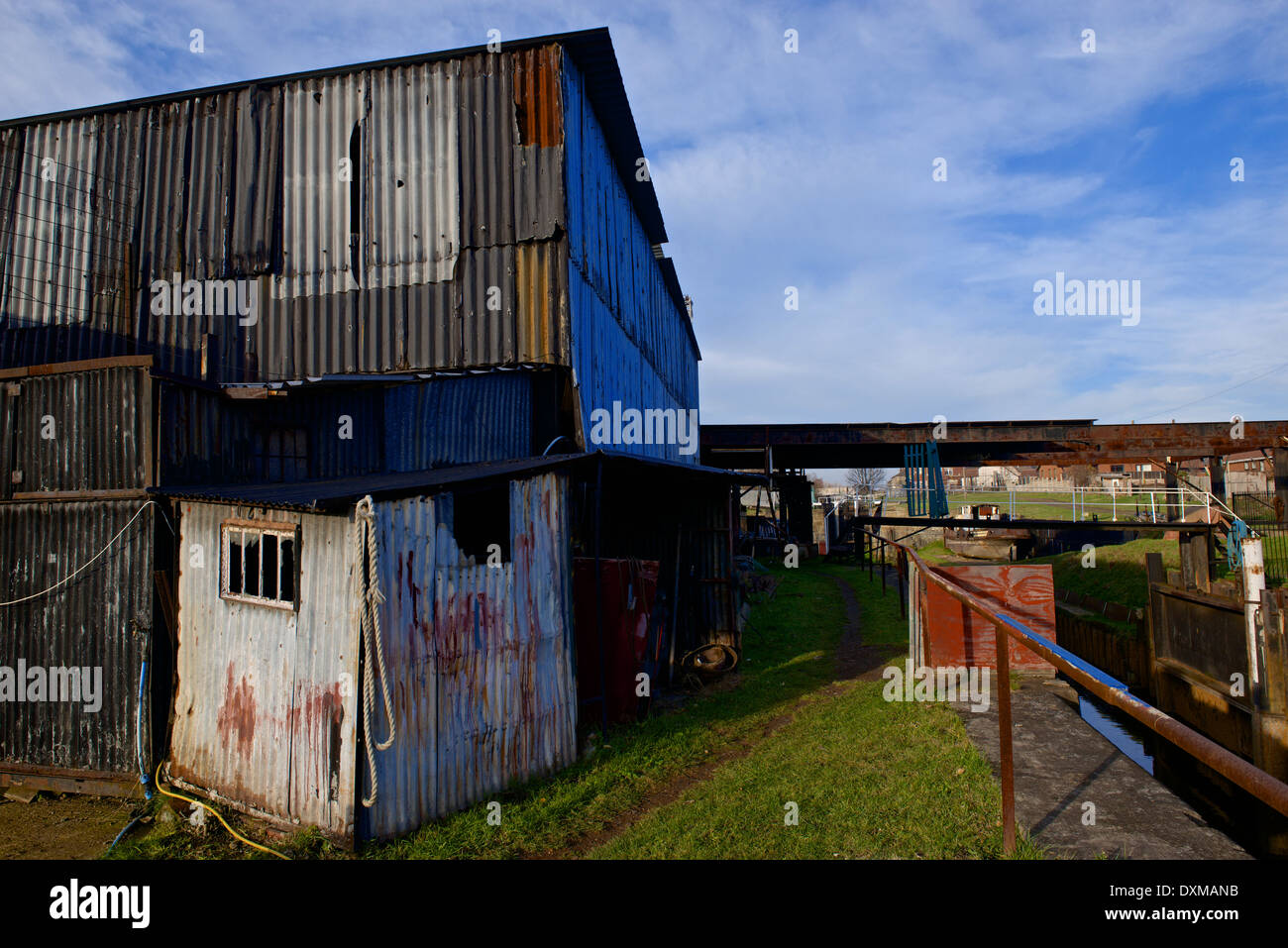 A ramshackle dilapidated rundown corrugated steel industrial building. Industrial decline concept Stock Photo