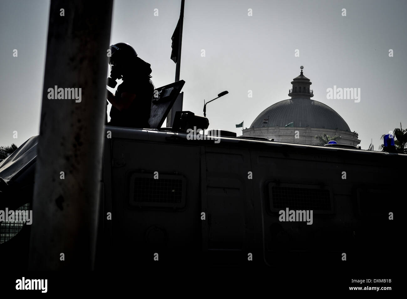 Cairo, Egypt. 26th Mar, 2014. Cairo university students clash with riot police in front of the university. The police fired tear gas and students threw stones and fireworks .a 17 years old boy was shot in his head, Cairo, Egypt, on March 26, 2014. © Mahmoud Shahin/NurPhoto/ZUMAPRESS.com/Alamy Live News Stock Photo