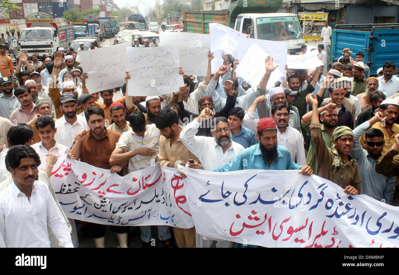 Members of Ice Dealer Association blocked road as they are protesting against extortion mafia during demonstration at Fishery area in Karachi on Thursday, March 27, 2014. Stock Photo