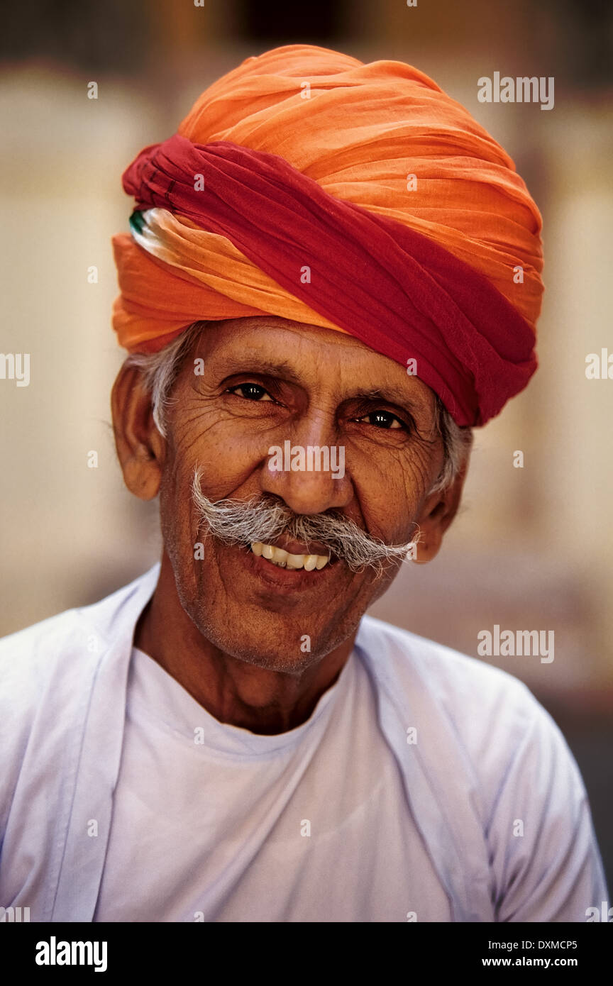 Portrait of Indian man with grey moustache and orange turban at Mehrangarh Fort in Jodhpur, India Stock Photo