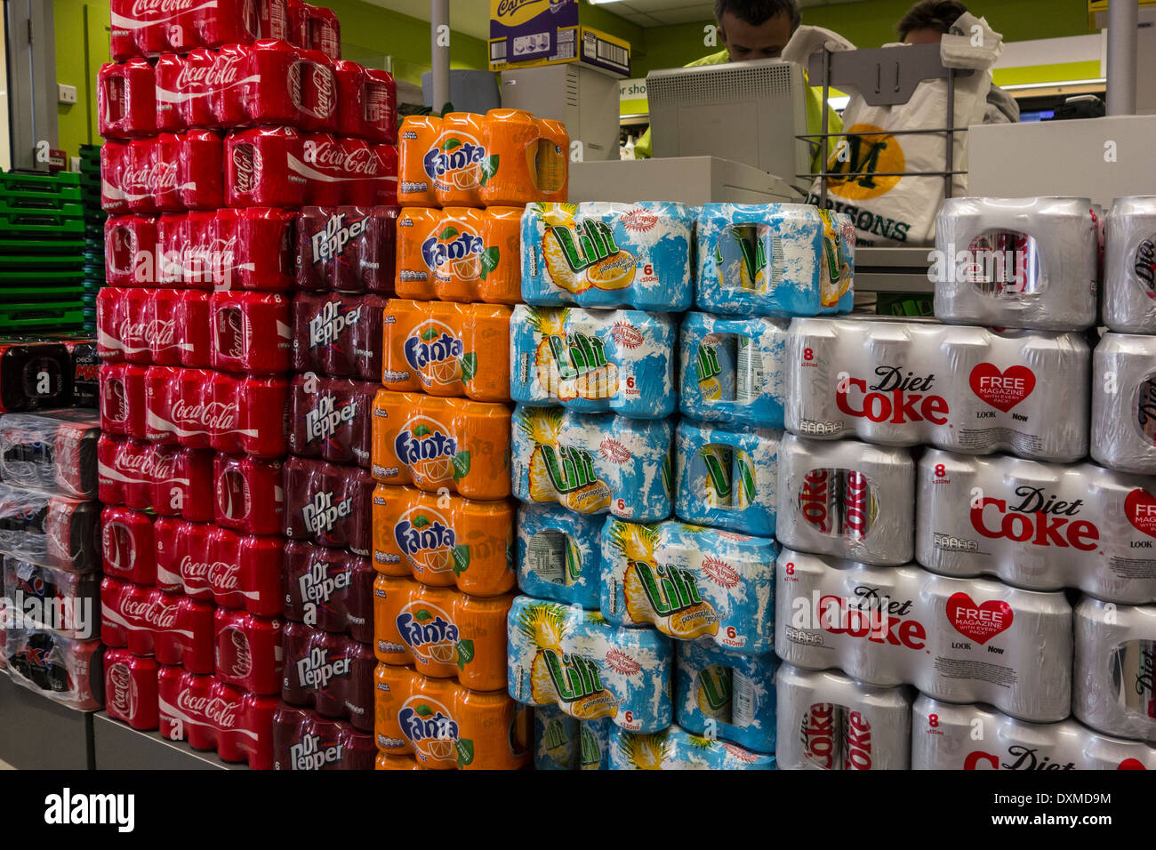Cans of soft drinks piled high in a supermarket Stock Photo Alamy