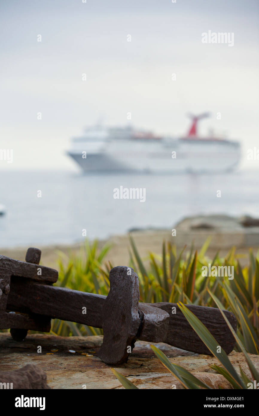 A Rusting Ships Anchor And the Anchored Cruise Ship Carnival Imagination, Avalon, Catalina Island, California. Stock Photo
