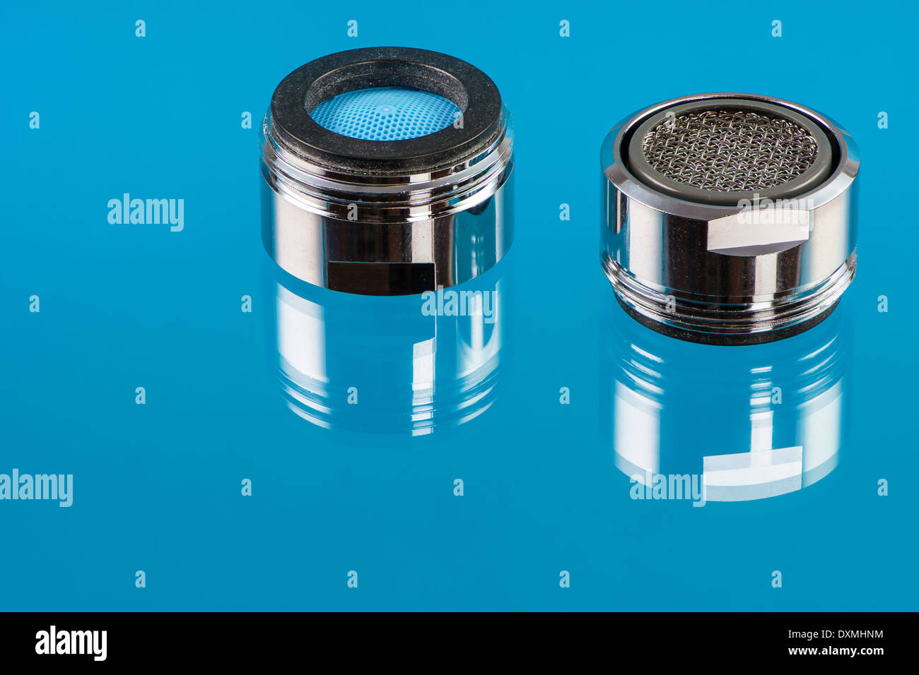 Macro of two faucet aerators for reducing water consumption. Stock Photo