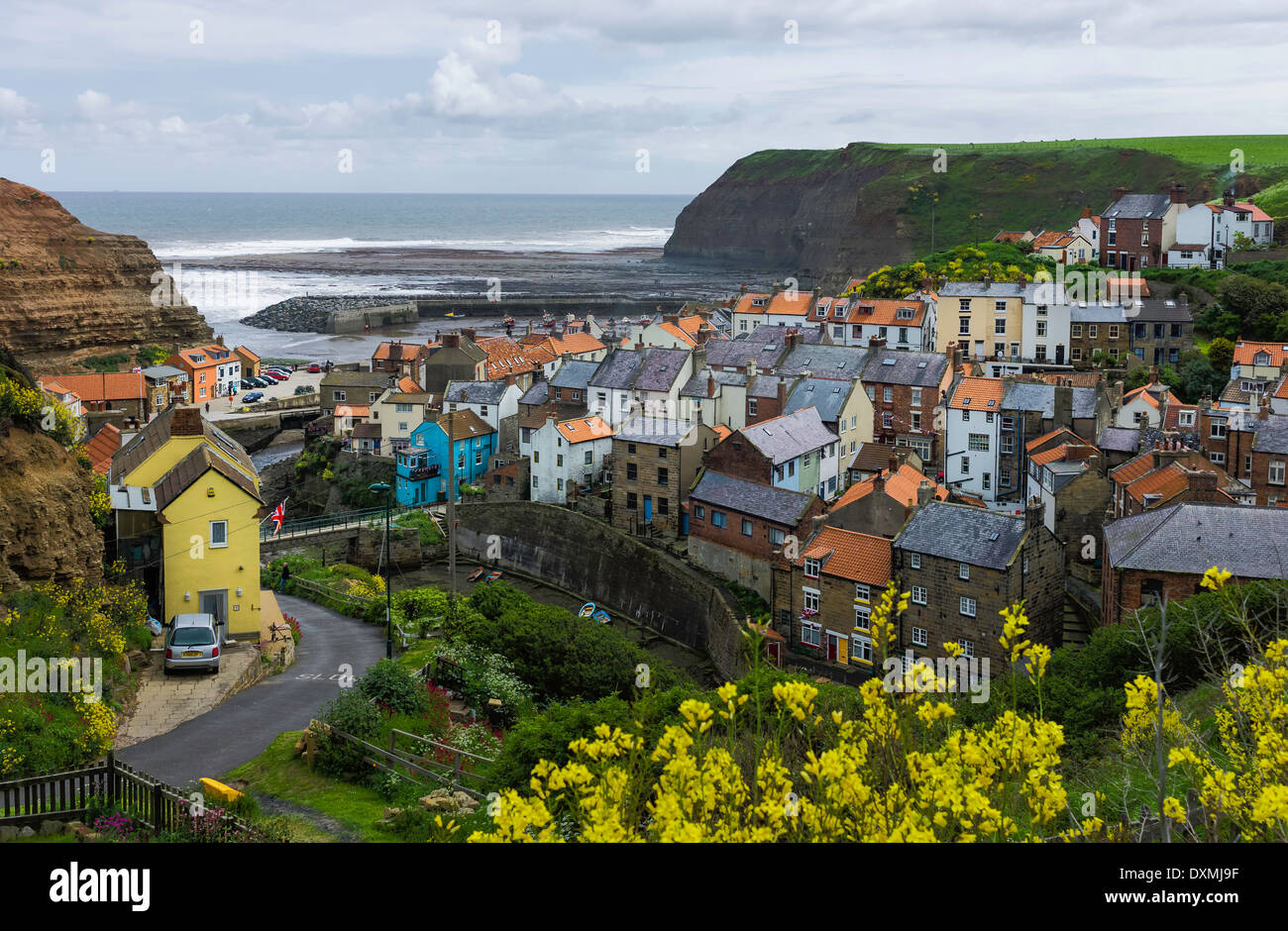 Staithes harbour showing the North Sea and houses clustered around the
