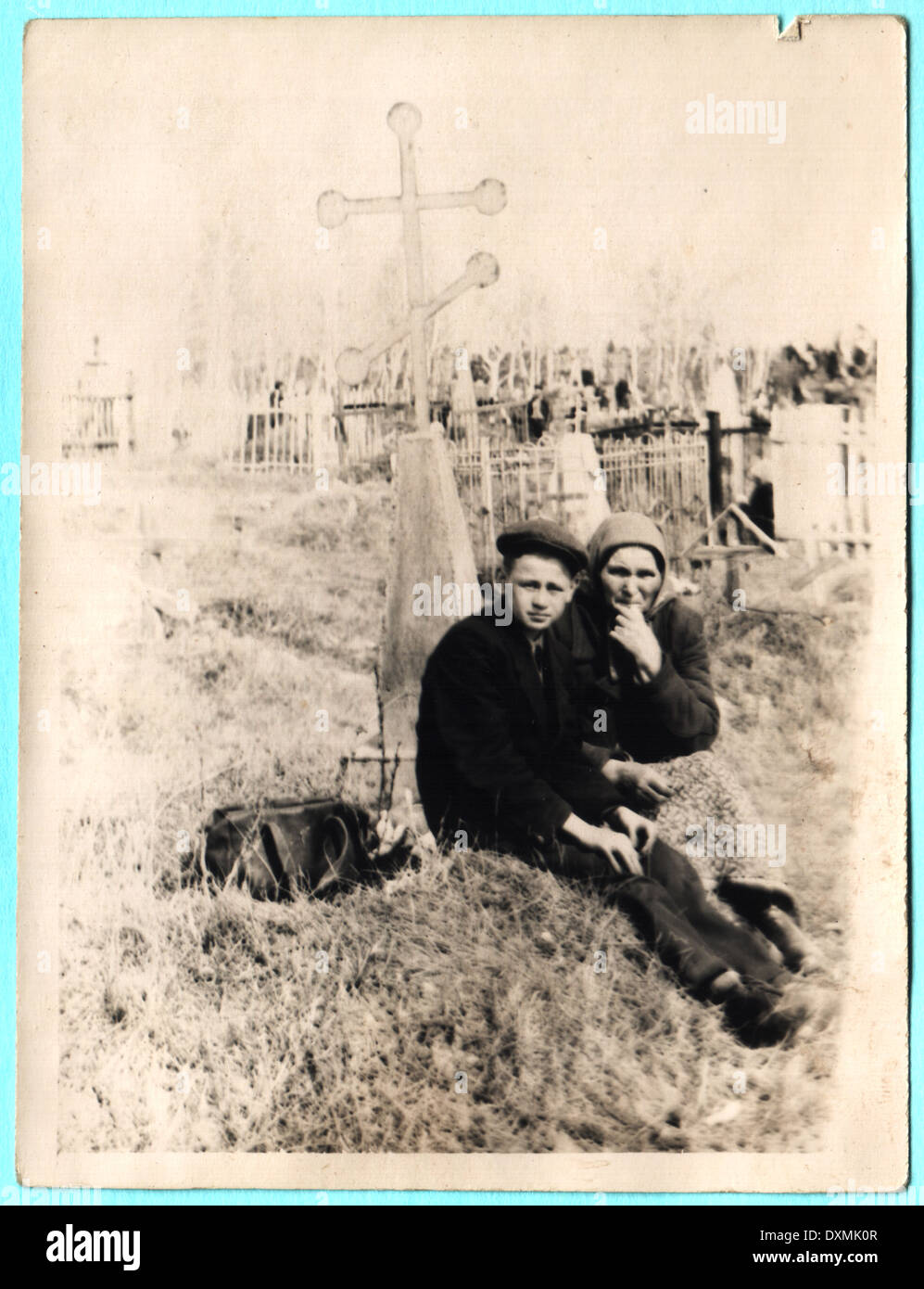 USSR - CIRCA 1930s: Grand mother with her grand son sitting on grave Stock Photo