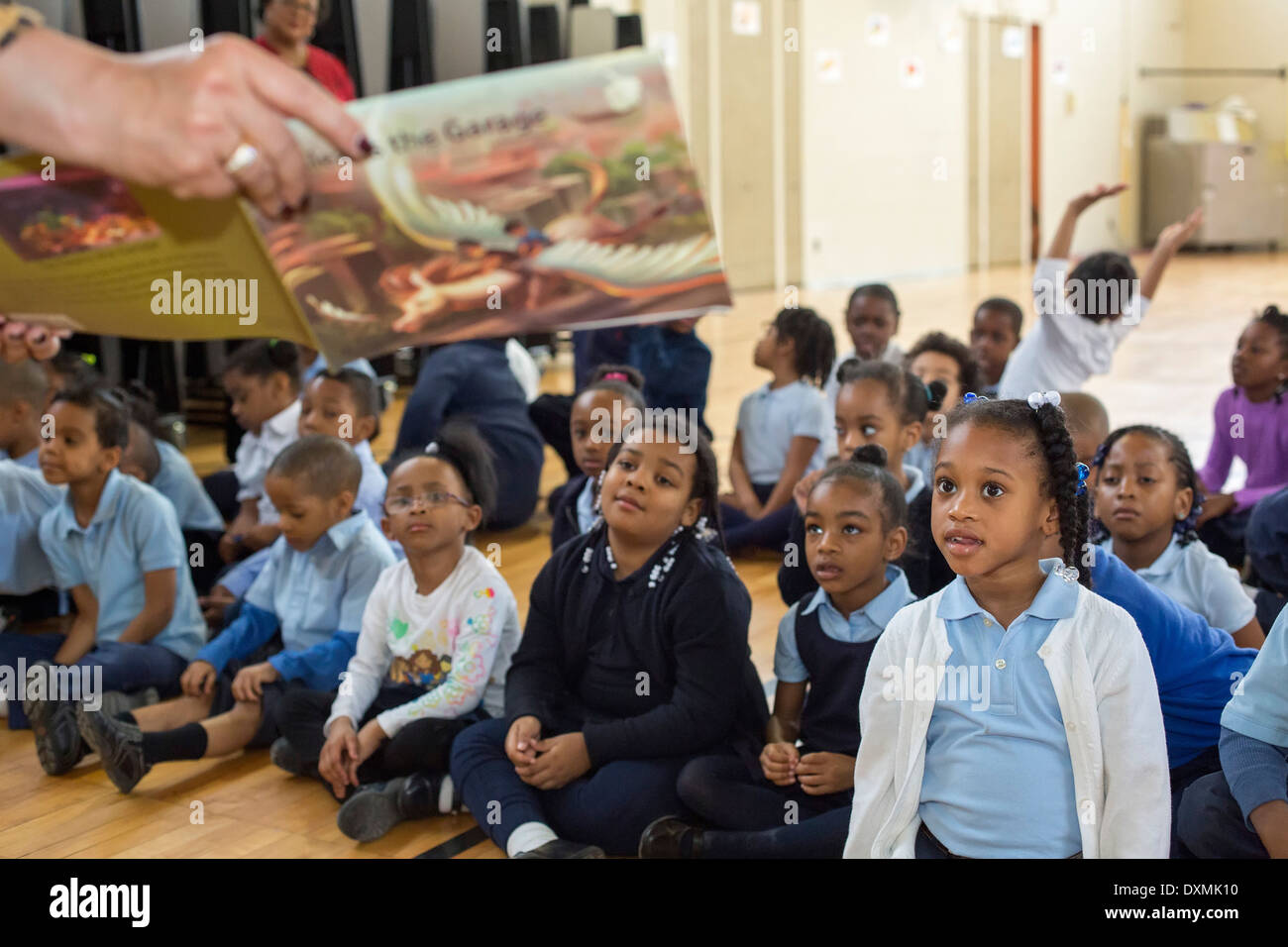 Kindergarten and first grade students at Chrysler Elementary School listen as author Renee Prewitt reads her book to them. Stock Photo