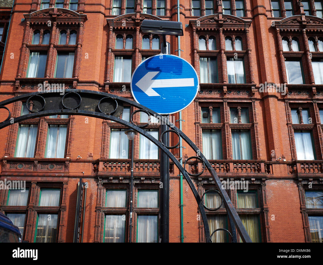 Turn left traffic sign in front of Palace hotel in Manchester UK Stock Photo