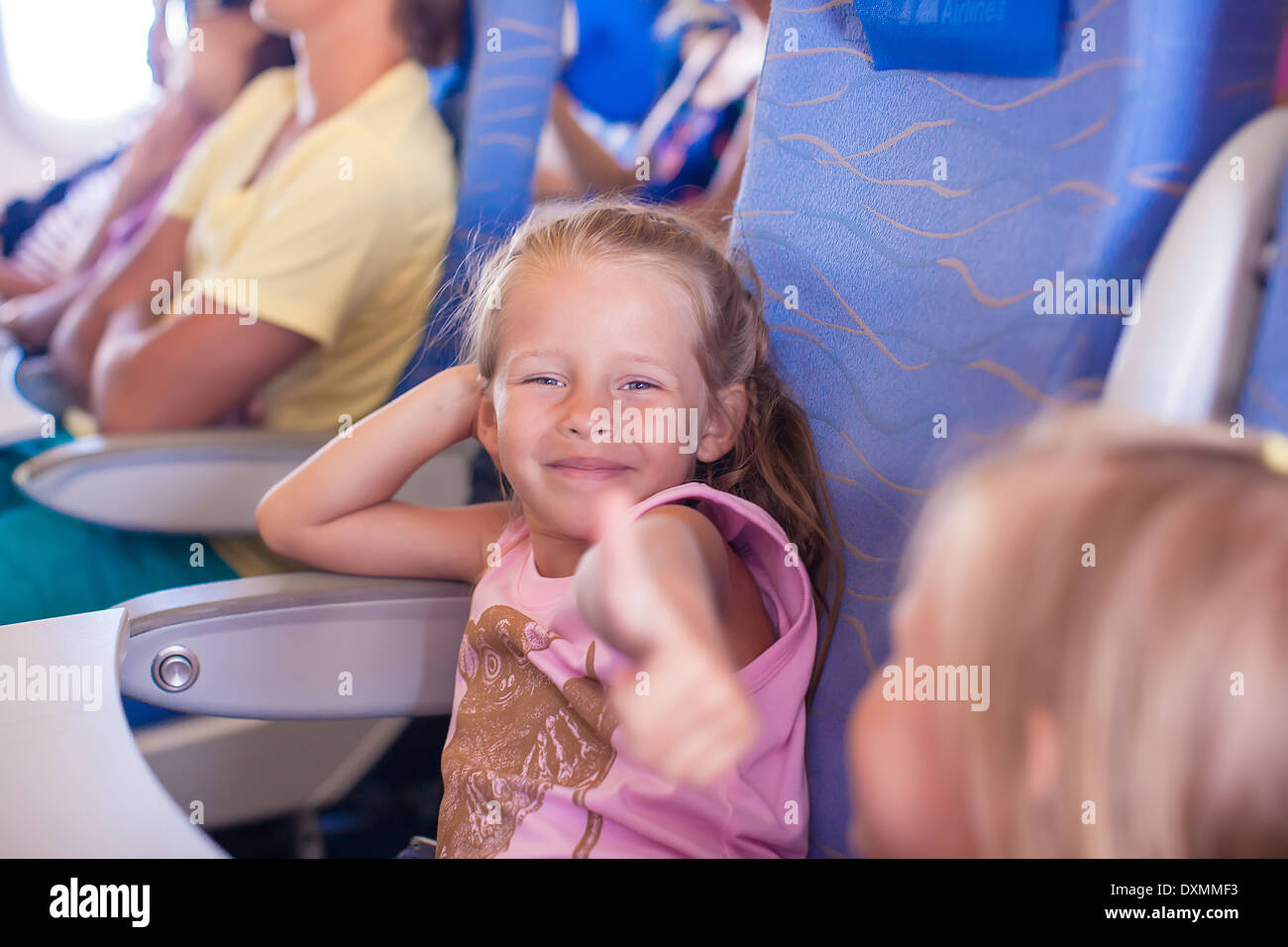 Little happy girl in the airplane Stock Photo - Alamy