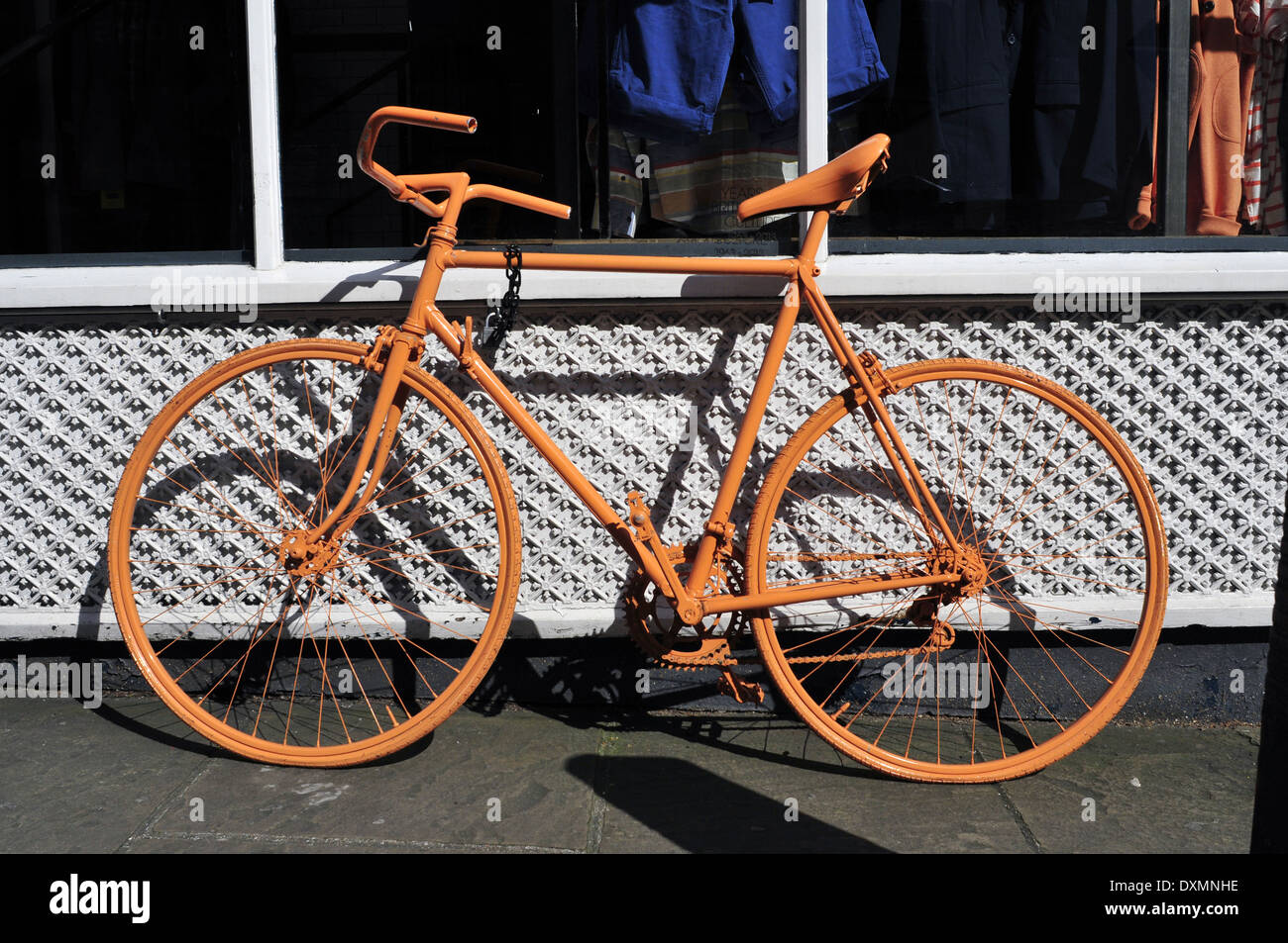 An orange bicycle parked in Angel, London, UK Stock Photo