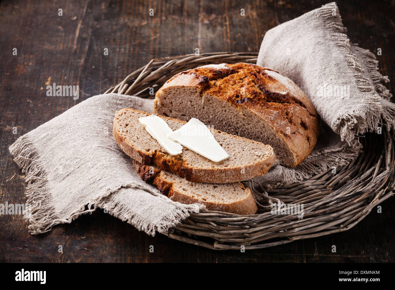 Rye bread and butter on wooden table Stock Photo