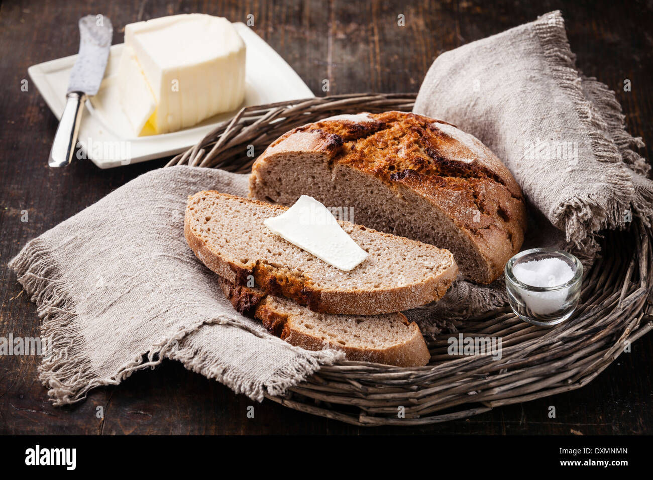 Rye sliced bread and butter on wooden table Stock Photo