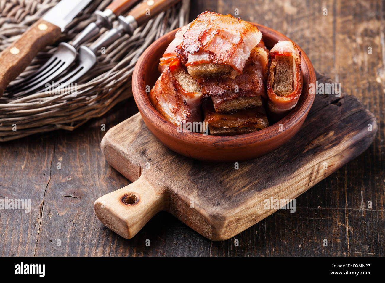 Appetizer bread slices fried in bacon Stock Photo
