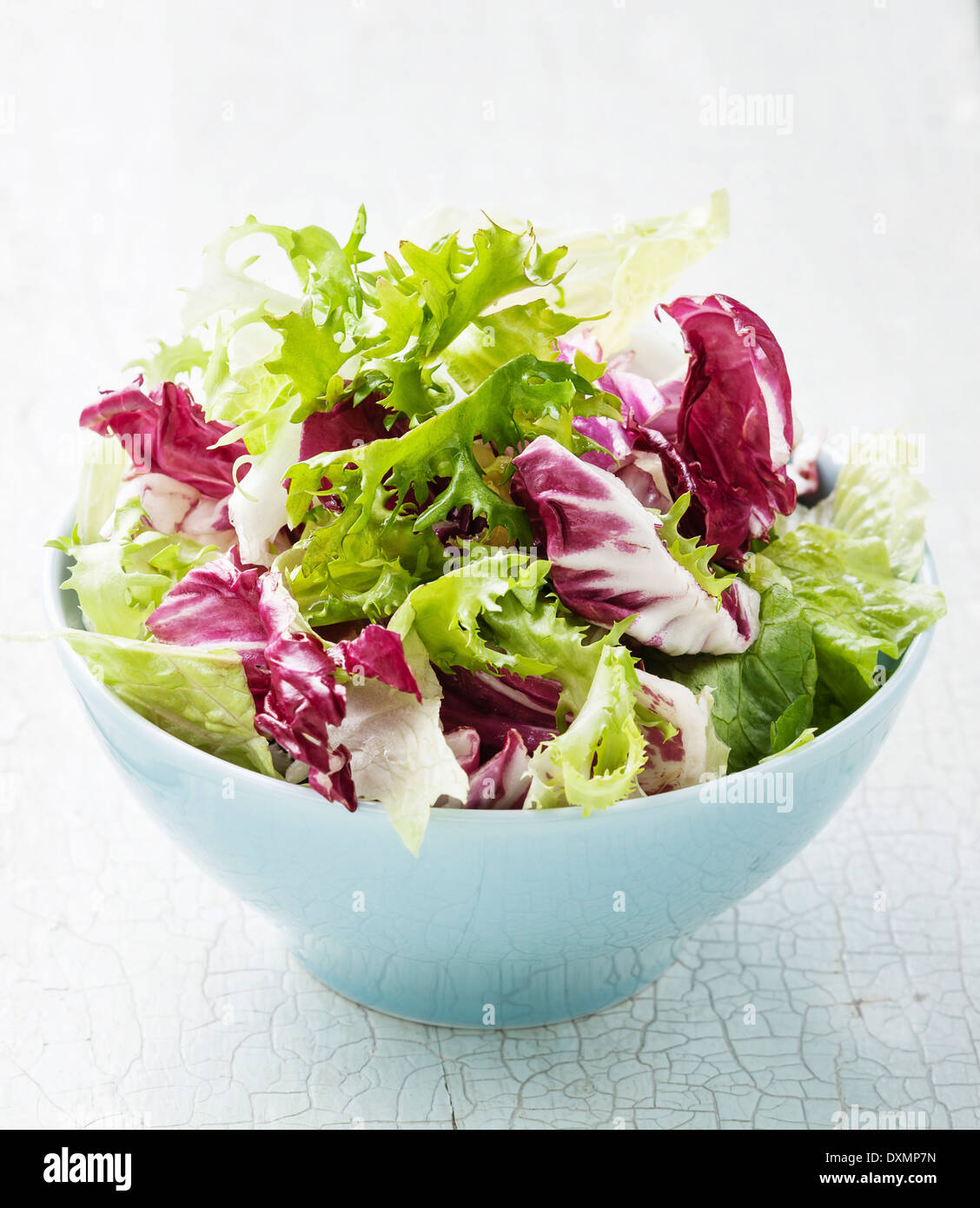 Fresh salad leaves mix in blue bowl Stock Photo