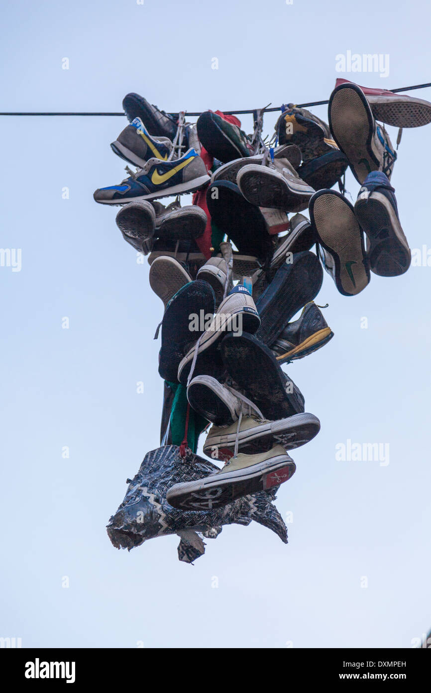 Shoe flingingshoefititossed shoes and trainer over powerline Stock