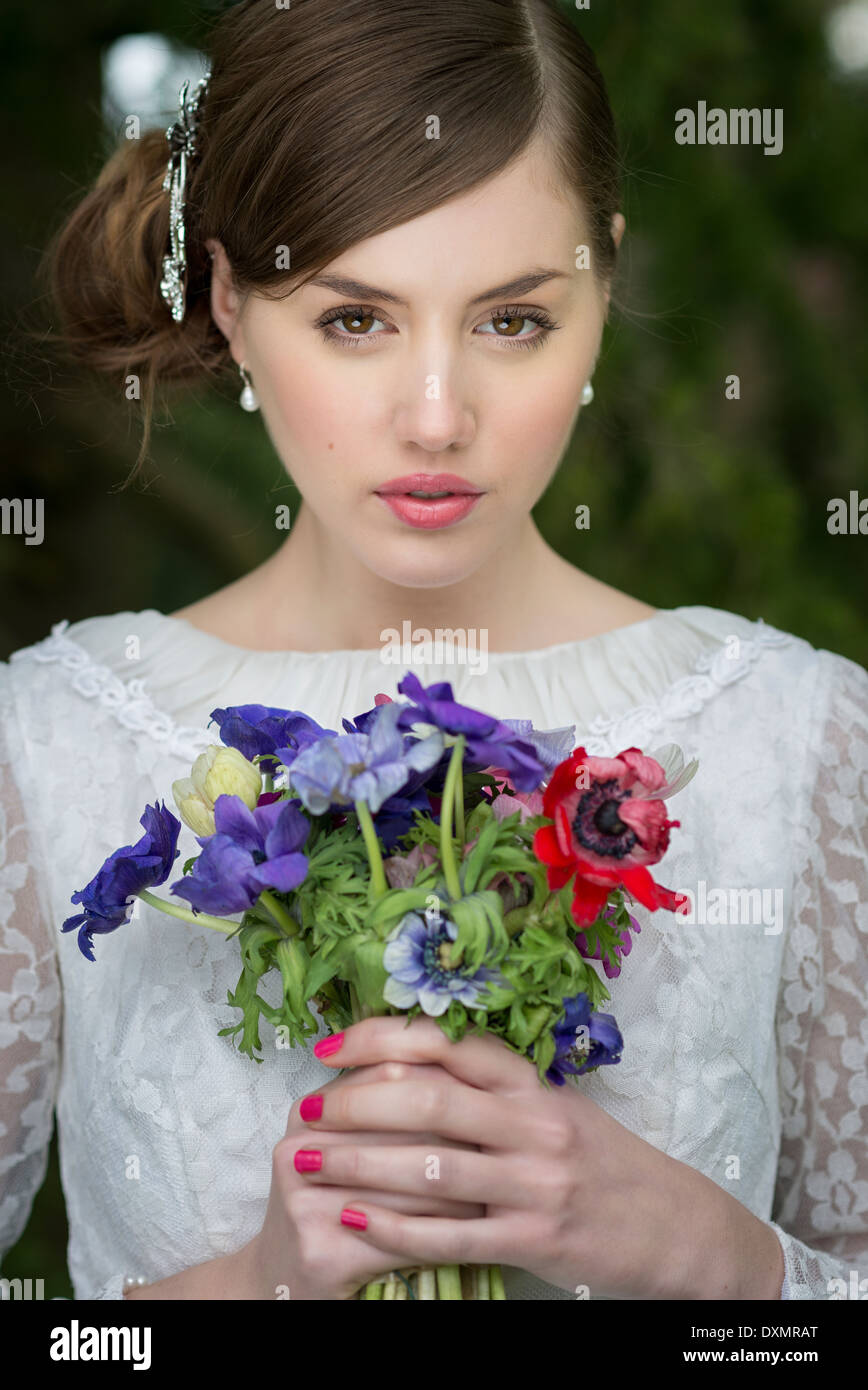Young bride with wild flowers bouquet Stock Photo