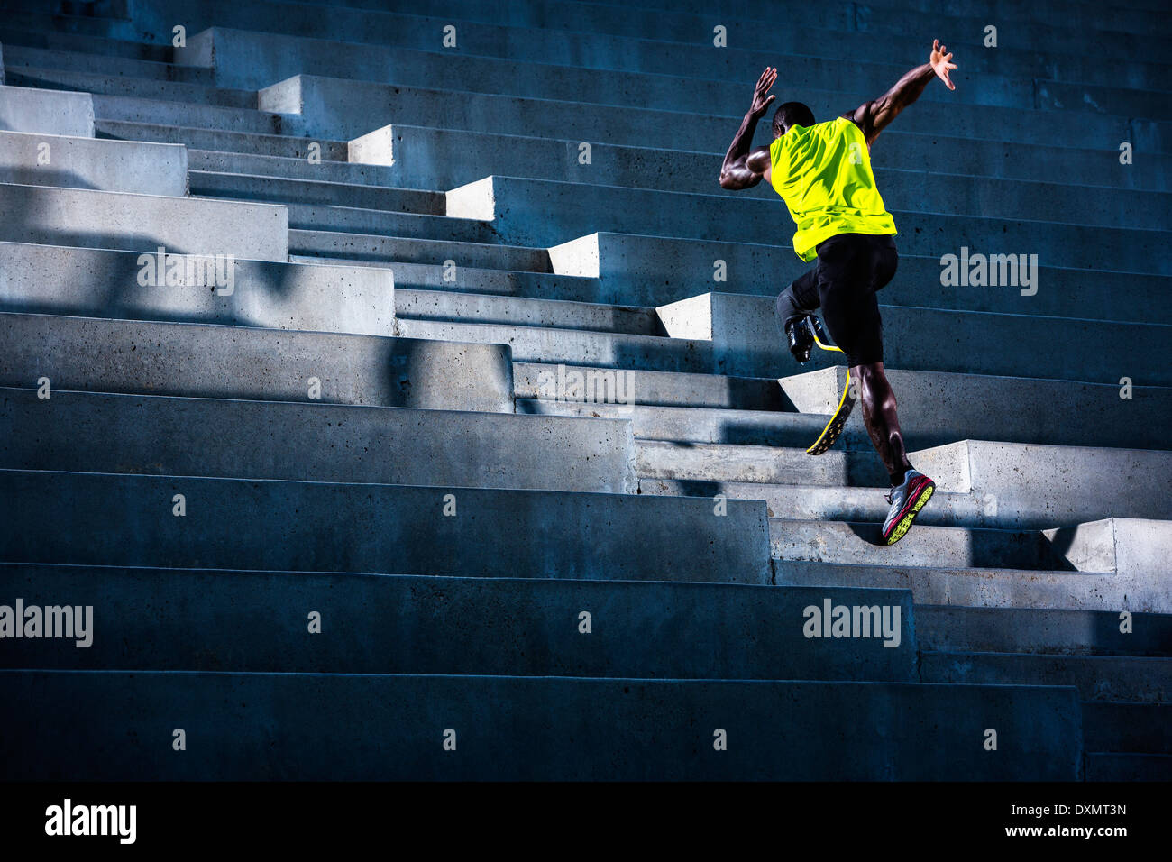 A wounded veteran athlete trains on stadium stairs. Stock Photo