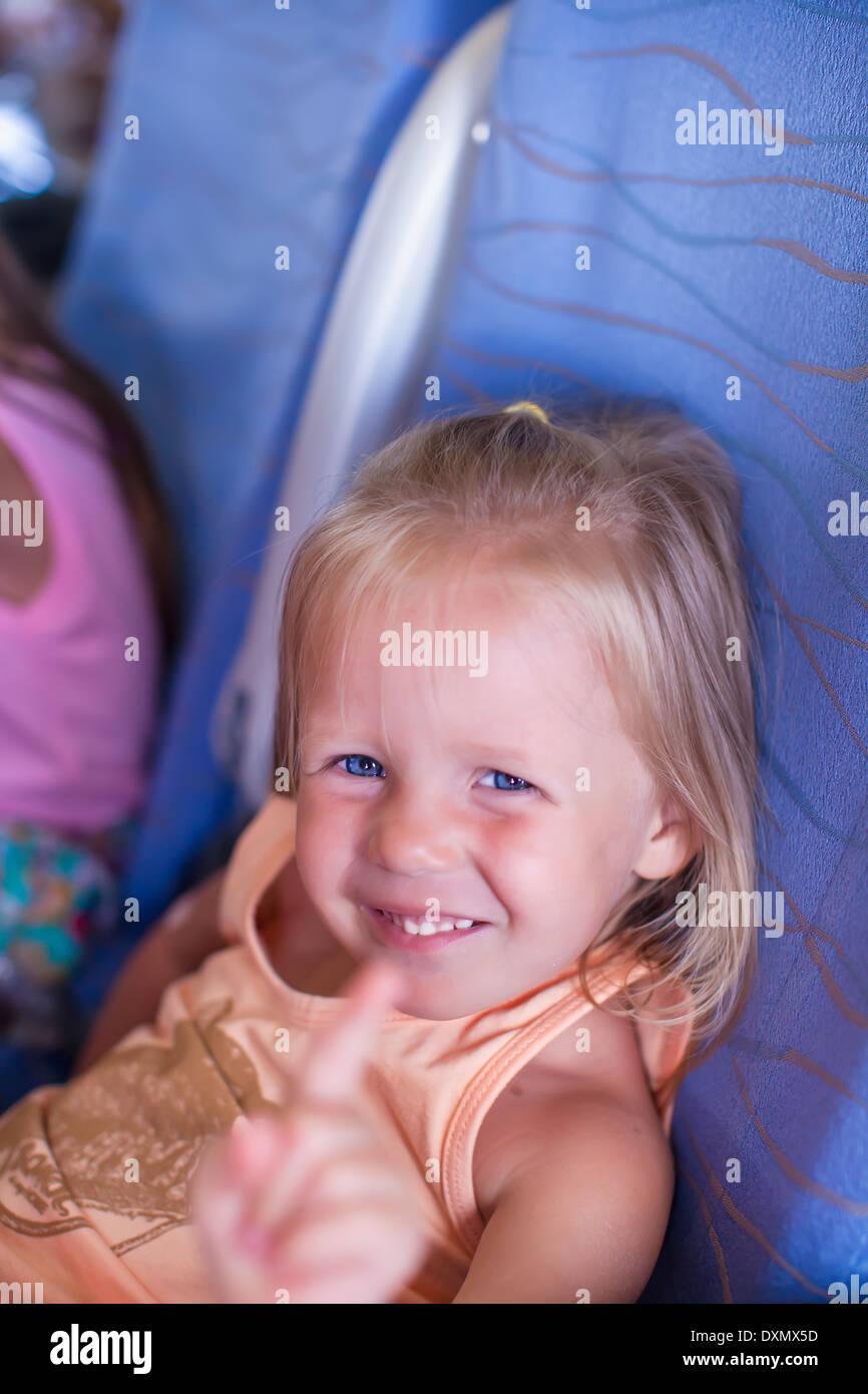 Little smiling happy girl in the airplane Stock Photo - Alamy