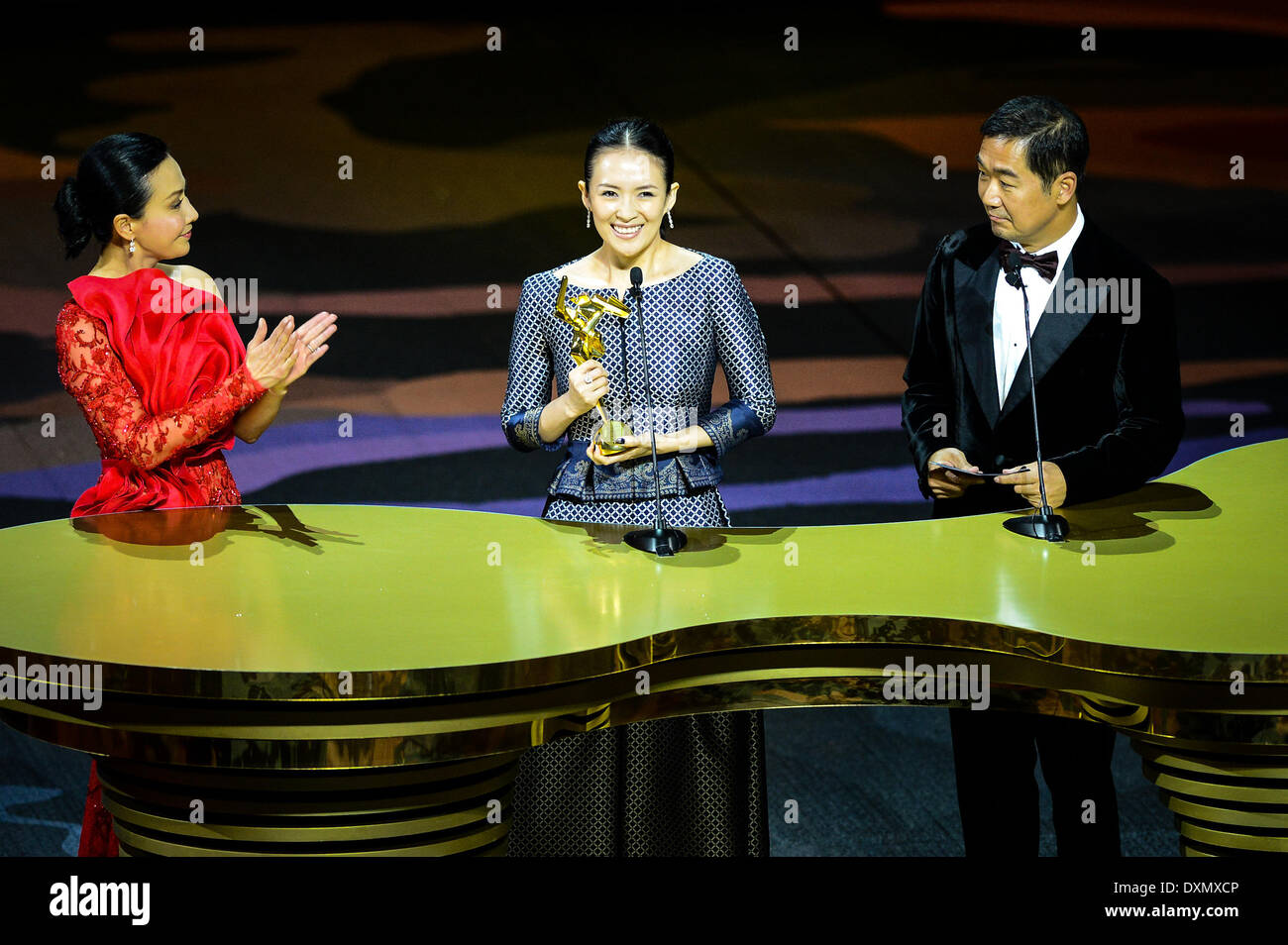 Macao, China. 27th Mar, 2014. Actress Zhang Ziyi (C) speaks after winning the Best Actress Award for her movie 'The Grandmaster' during the Asian Film Awards ceremony in Macao, south China, March 27, 2014. © Cheong Kam Ka/Xinhua/Alamy Live News Stock Photo