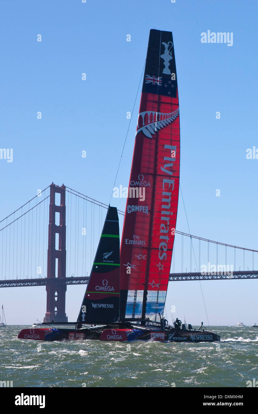 Emirates Team New Zealand skippered by Dean Barker sails past the Golden Gate Bridge in the San Francisco Bay during the 2013 America's Cup Finals San Francisco, California. Stock Photo