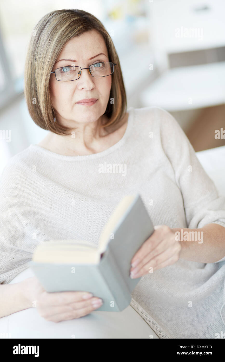 Portrait of woman wearing eyeglasses with a book Stock Photo