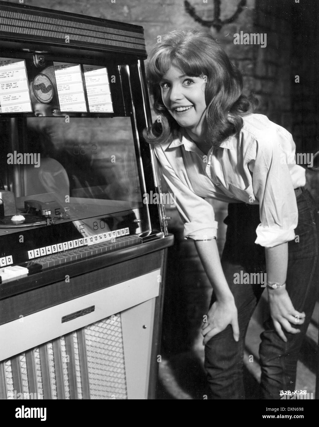 JANE ASHER listening to a juke box whilst making the film GI Stock Photo