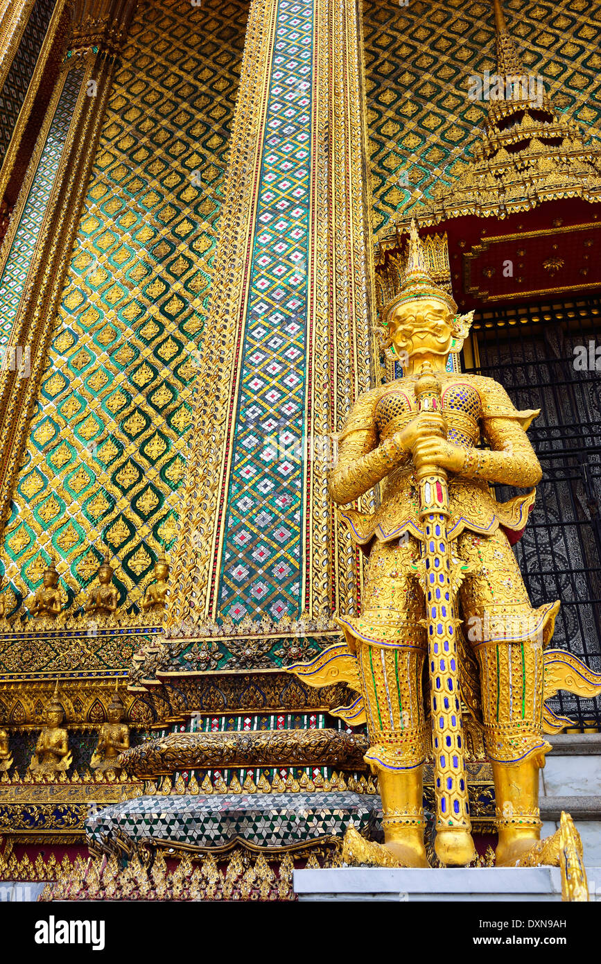 Gold figure of Yaksha, a demon, outside the Phra Mondop Library in the Wat Phra Kaew temple complex, Bangkok, Thailand Stock Photo