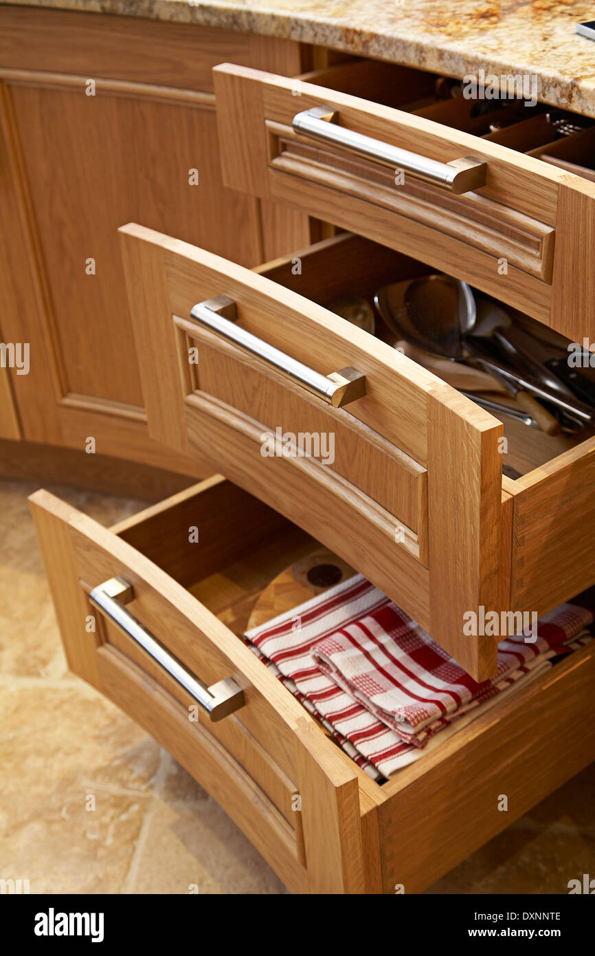 Rounded drawers opened in a modern  British kitchen. Stock Photo