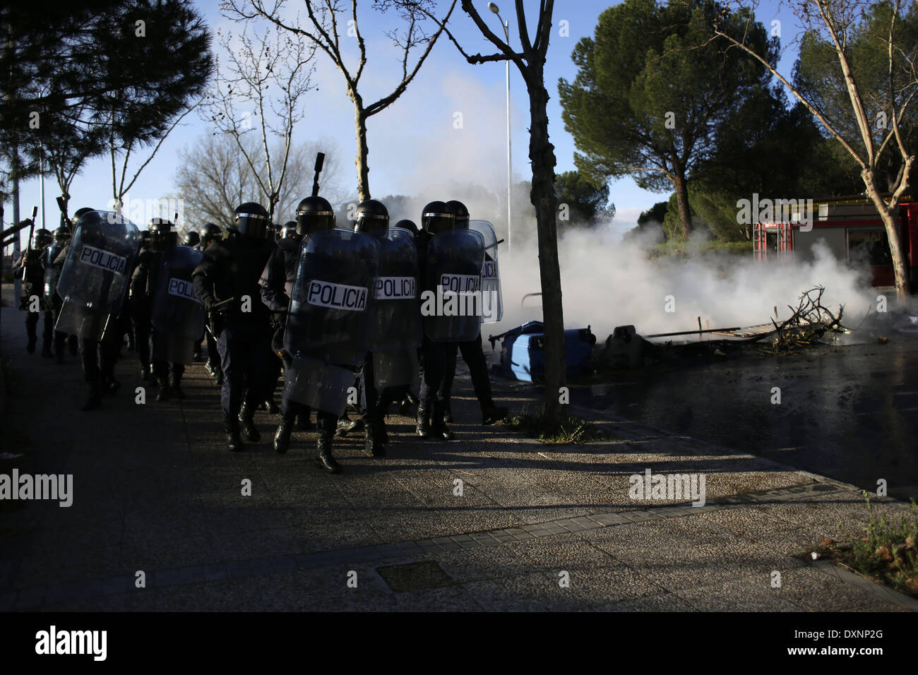 Madrid, Spain. 27th Mar, 2014. Riot police walks next to a barricade ...