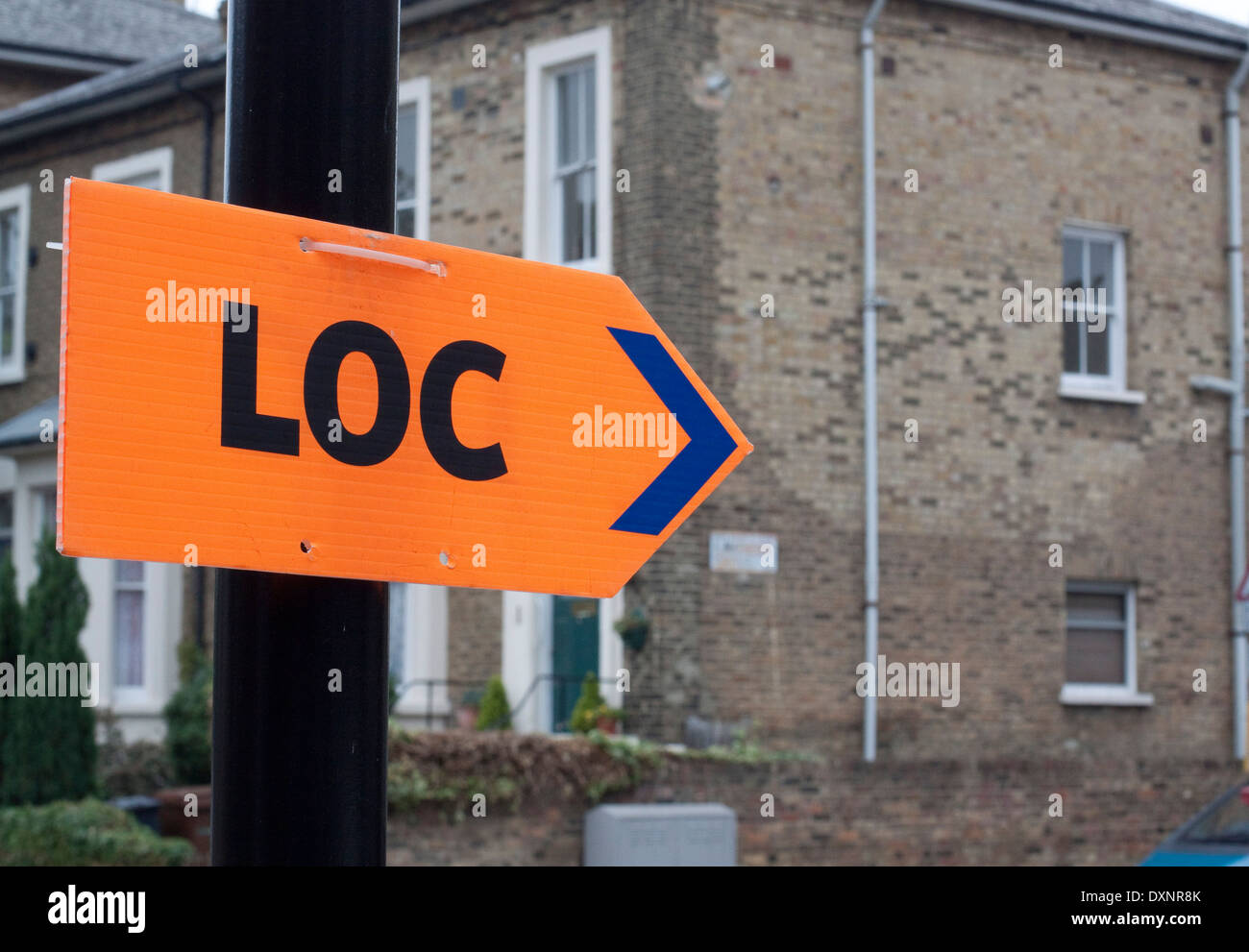 Orange LOC sign directing a film unit to an urban location Stock Photo