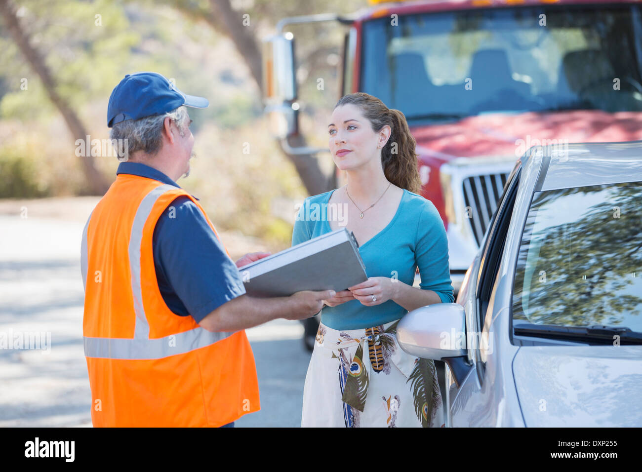 Roadside mechanic talking with woman Stock Photo