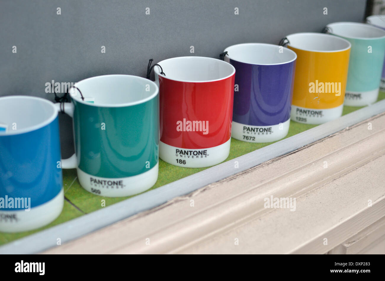 Pantone Matching System (PMS) colours on mugs in a shop window Stock Photo