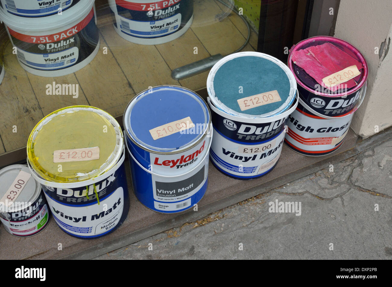 Second hand paint tins on display outside a shop, London, UK Stock Photo