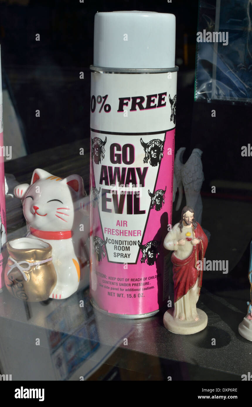 A shop window display showing a can of spray which claims to eradicate evil Stock Photo