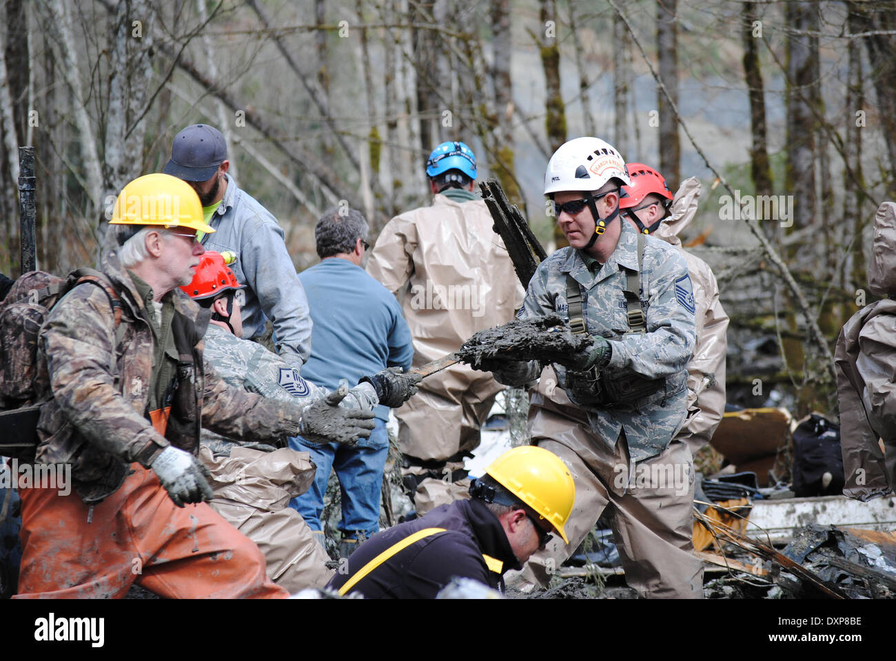 Rescue workers continue efforts to locate victims of a massive landslide that killed at least 28 people and destroyed a small riverside village in northwestern Washington state March 26, 2014 in Oso, Washington. Stock Photo