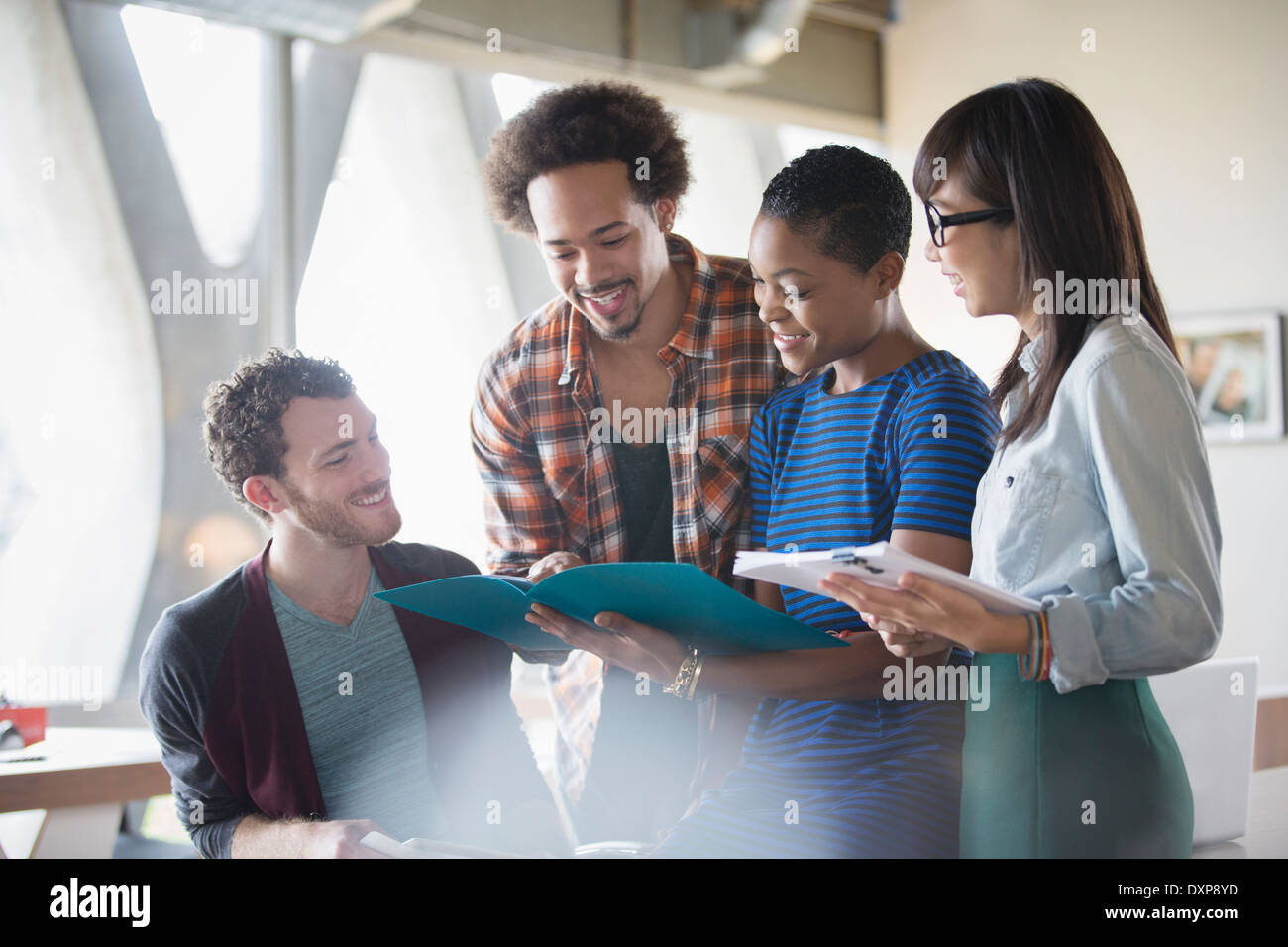 Creative business people reviewing paperwork in meeting Stock Photo - Alamy
