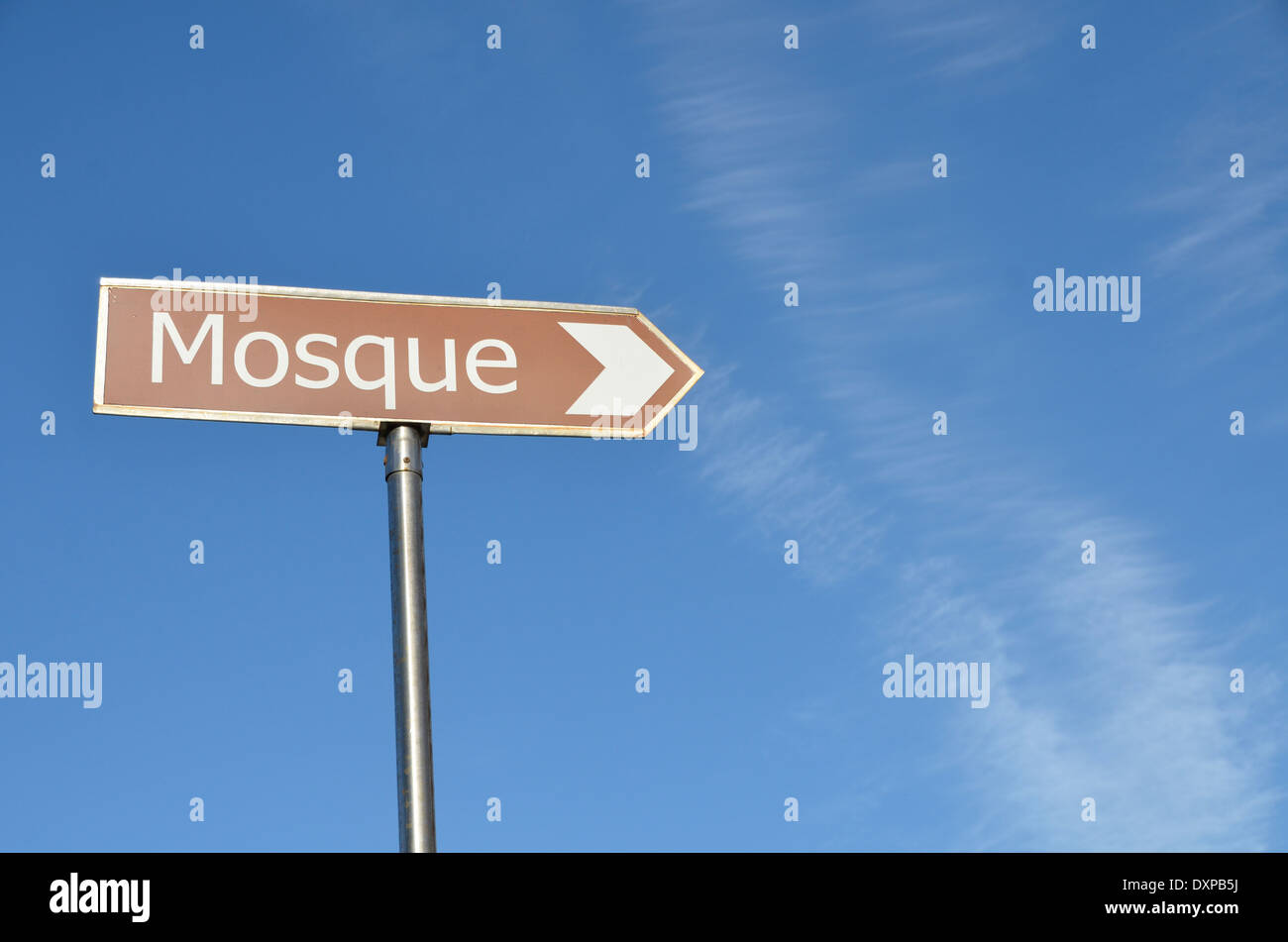 Mosque direction sign against a blue sky Stock Photo