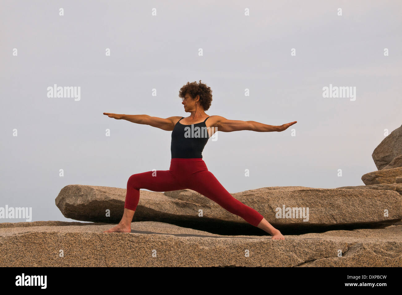 Iyengar Yoga Instructor Demonstrates Virabhadrasana 2 (Standing Stock