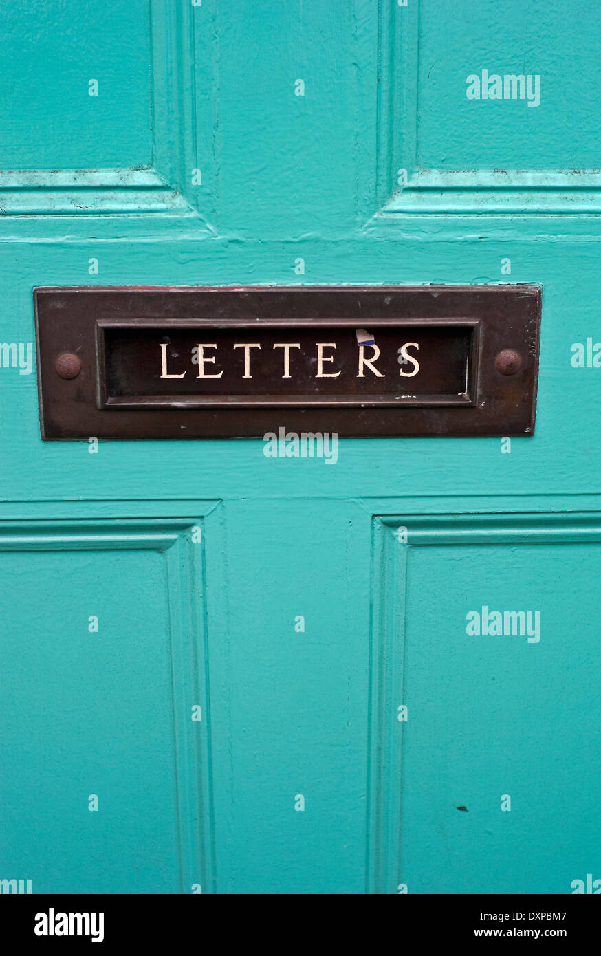 Aqua marine colored front door letterbox with the word letters on it Stock Photo