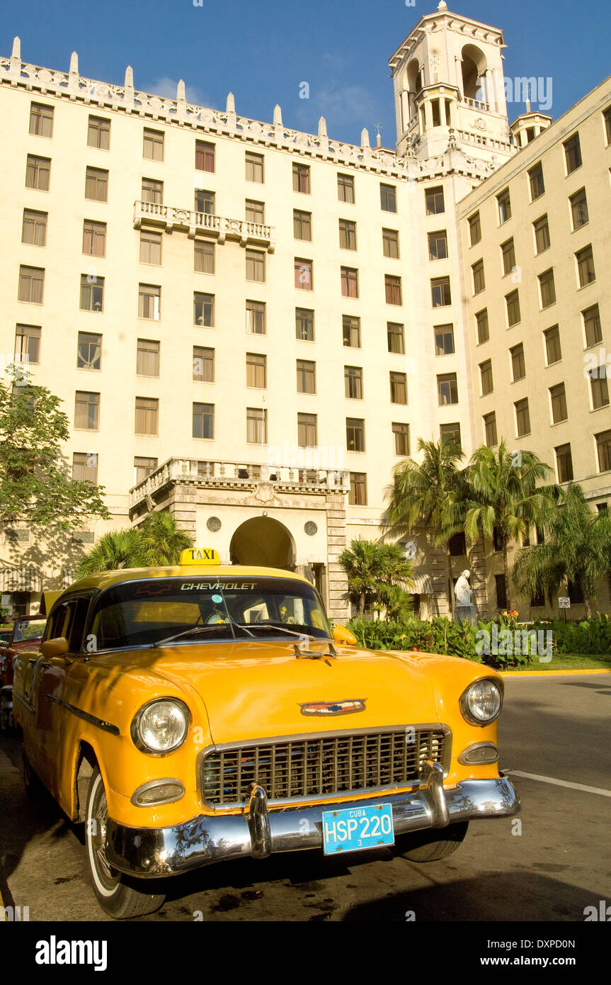 A yellow1950's Chevrolet taxi cab outside the Hotel Nacional, Havana, Cuba Stock Photo