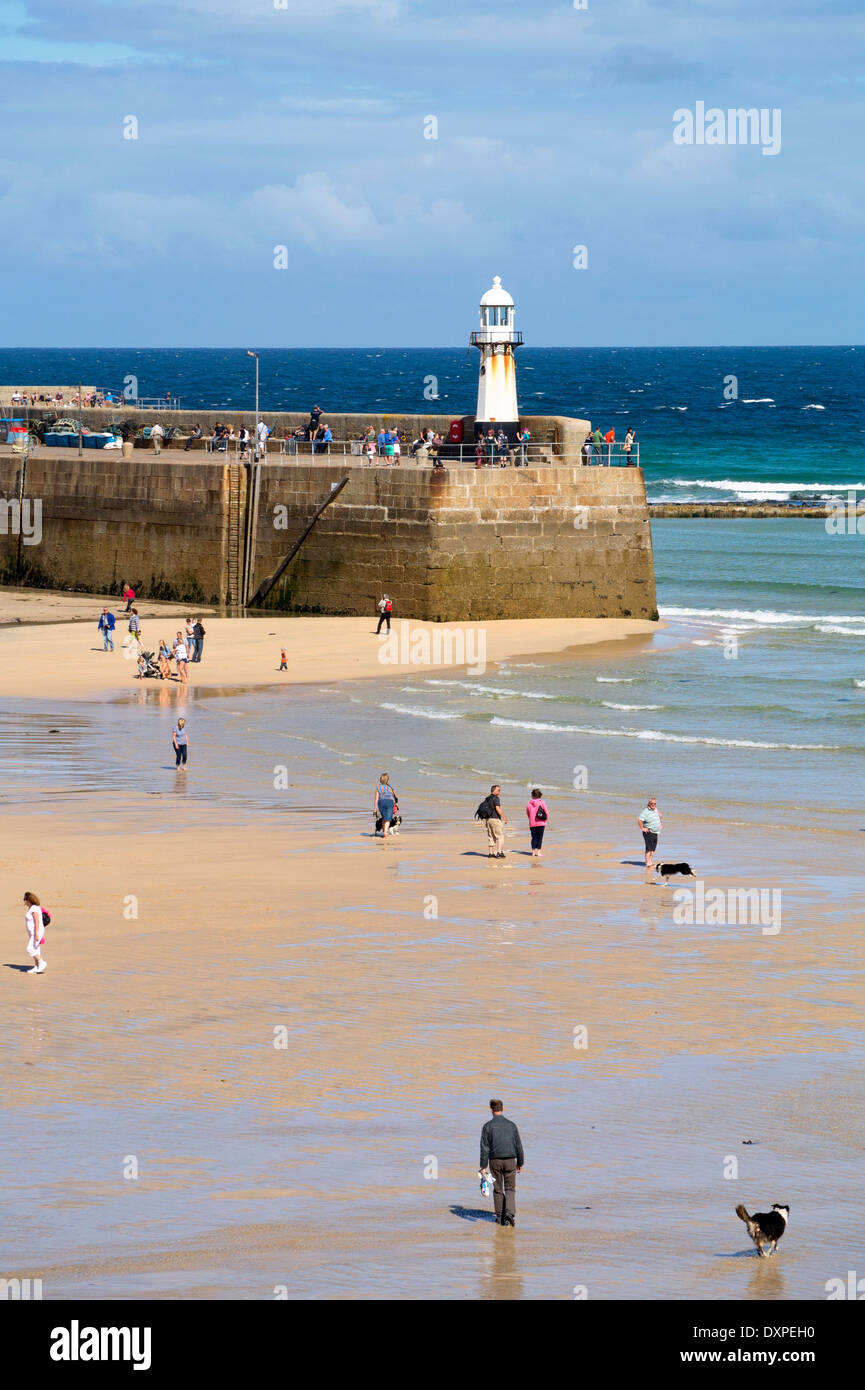 St. Ives harbour beach and pier on an autumn day as the tide comes in, Cornwall England. Stock Photo