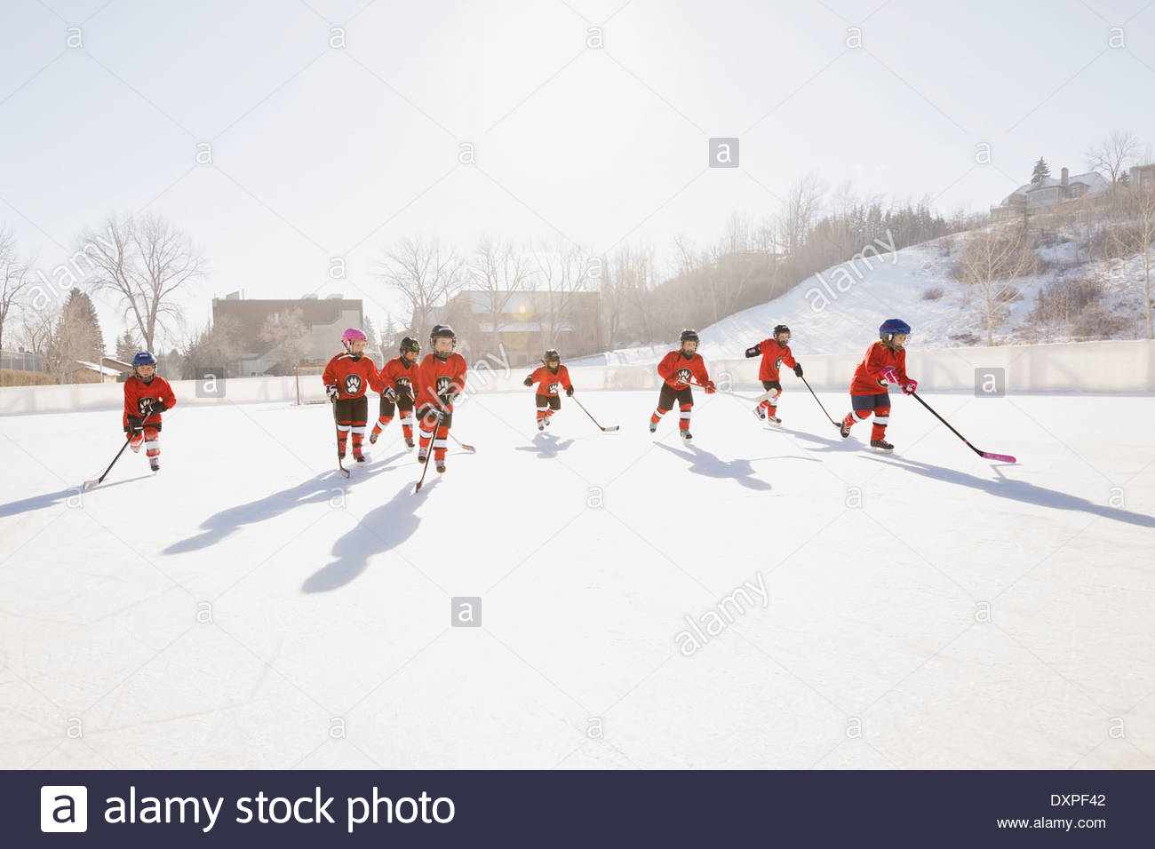 Ice hockey team skating on outdoor rink Stock Photo Alamy