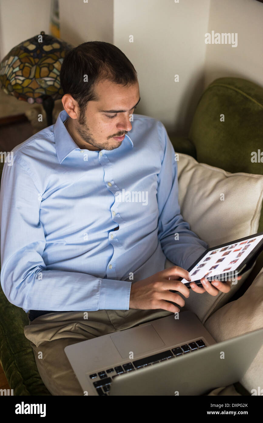 elegant business multitasking multimedia man using devices at home
